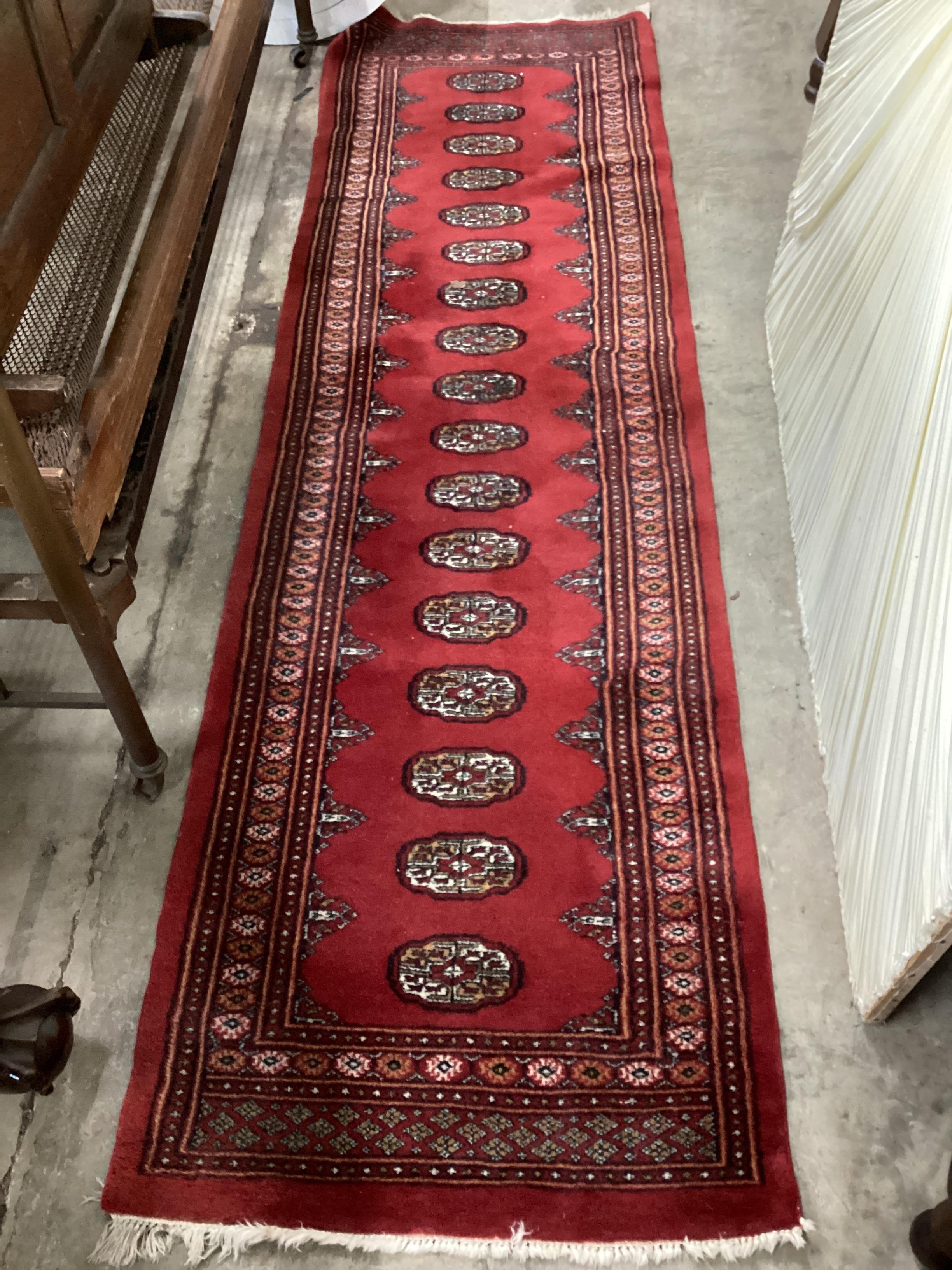 A Bokhara red ground runner, 276 x 82cm